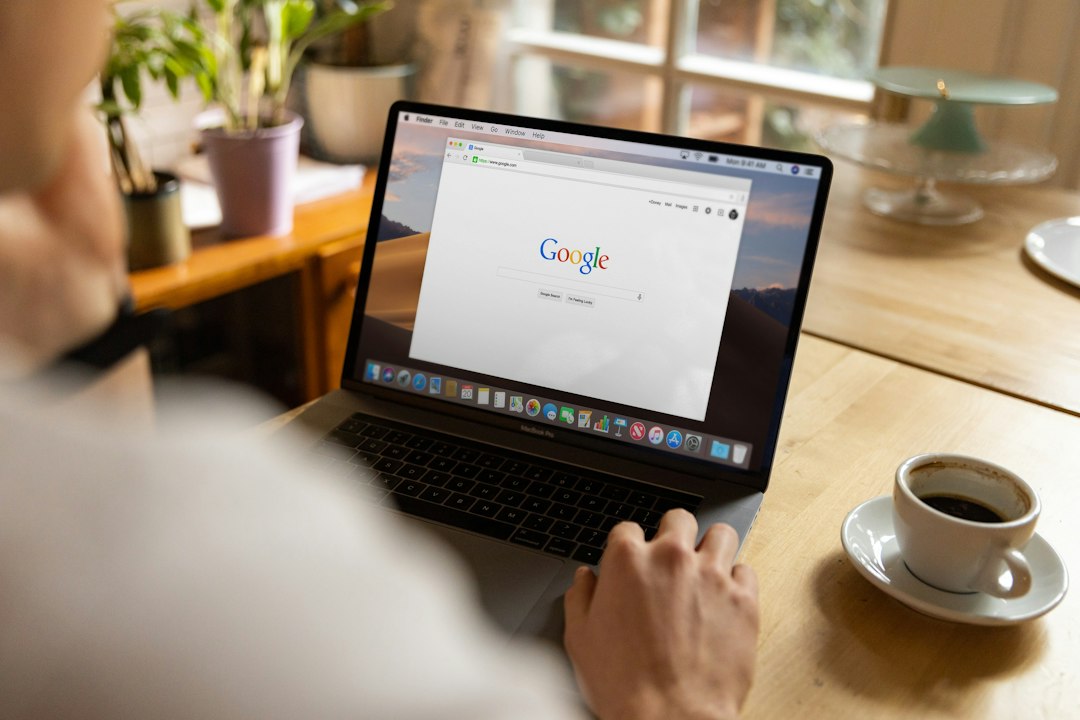 Home buscando en Google co portátil nunha cafetería